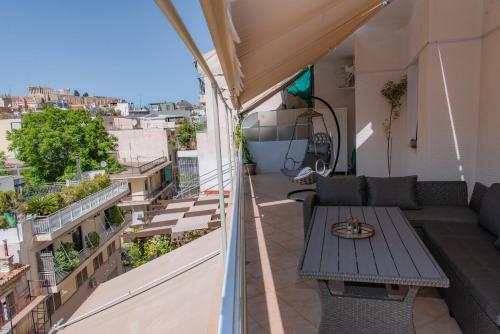 a balcony with a table and a view of the city at Pnyka Apartment 3 in Athens