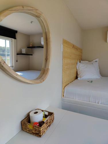 a bedroom with a bed with a mirror and a basket at Lianko - Vakantiewoning in Bekkevoort