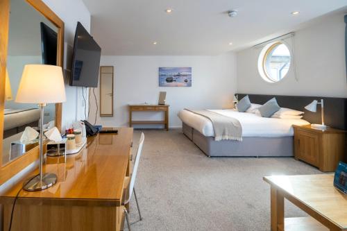 a hotel room with a bed and a desk with a desk at Portavadie Loch Fyne Scotland in Portavadie