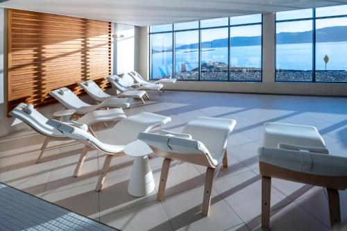 a waiting room with white chairs and windows at Portavadie Loch Fyne Scotland in Portavadie