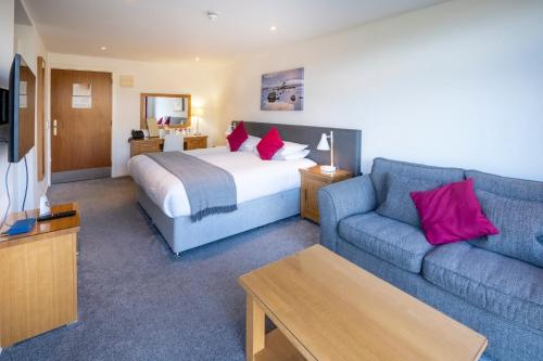 a hotel room with a bed and a couch at Portavadie Loch Fyne Scotland in Portavadie