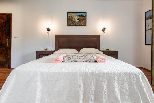 a bedroom with a bed with a white bedspread at Apartments and spa MIONA in Virpazar