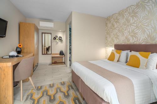 a bedroom with a large bed with a desk and a desk at Maison 66, Riviera Hotels in Athens