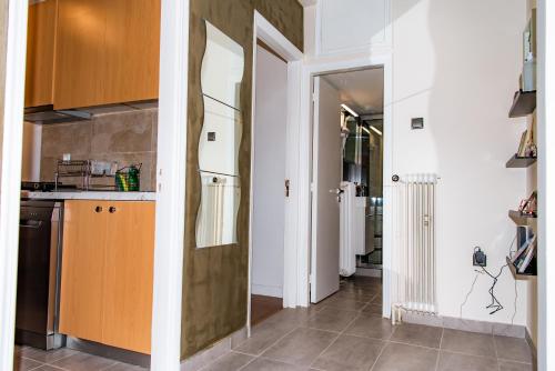 a kitchen with a door leading into a hallway at Pnyka Apartment 3 in Athens
