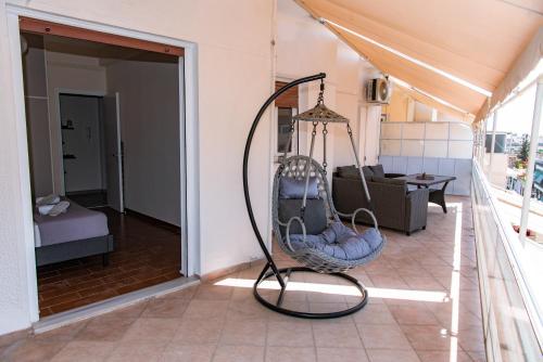 a porch with a swing in a house at Pnyka Apartment 3 in Athens