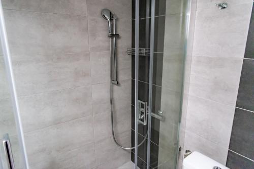 a bathroom with a shower with a glass door at Pnyka Apartment 3 in Athens