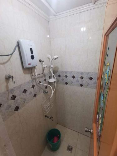 a bathroom with a shower with a soap dispenser at Comfy Dwelling in Baguio