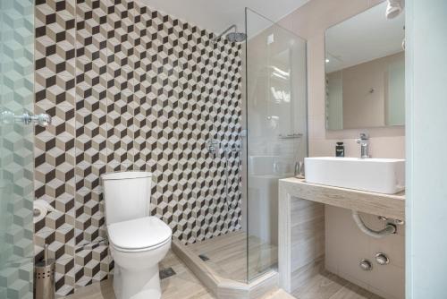 a bathroom with a toilet and a shower and a sink at Maison 66, Riviera Hotels in Athens