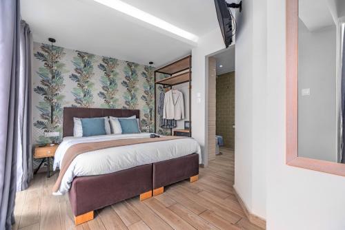 a bedroom with a large bed in a room at Maison 66, Riviera Hotels in Athens