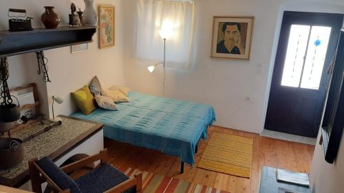 a small room with a bed and a door at House Markovina in Cres