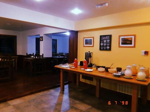 a room with a table with bowls and vases on it at OIKOS in Ushuaia