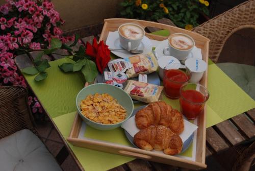 a tray of food with croissants and other foods on a table at Albergo Salerno in Milan