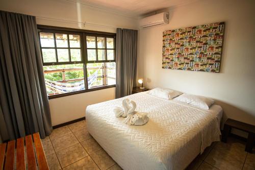 En eller flere senge i et værelse på Cabanas Praia Mole Florianopolis