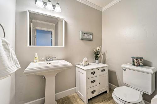 a bathroom with a sink and a toilet and a mirror at Scenic Mancos Hideaway Less Than 2 Mi to Mesa Verde! in Mancos