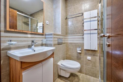 a bathroom with a sink and a toilet at Monix Palace Zlatibor in Zlatibor