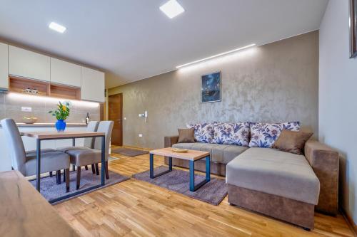 a living room with a couch and a table at Monix Palace Zlatibor in Zlatibor