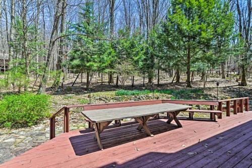 a wooden picnic table sitting on a wooden deck at Family-Friendly Terra Alta Home with Lake View! in Terra Alta