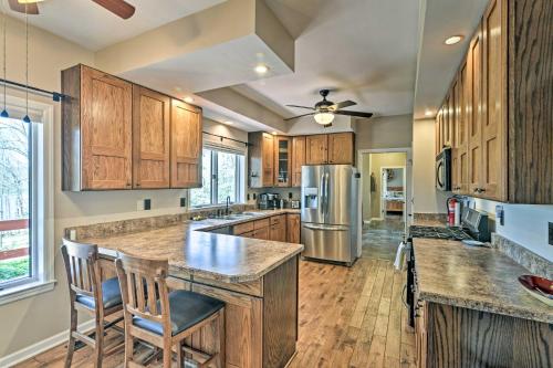 a kitchen with wooden cabinets and a large island at Family-Friendly Terra Alta Home with Lake View! in Terra Alta