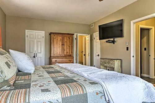 a bedroom with a bed and a flat screen tv at Family-Friendly Terra Alta Home with Lake View! in Terra Alta
