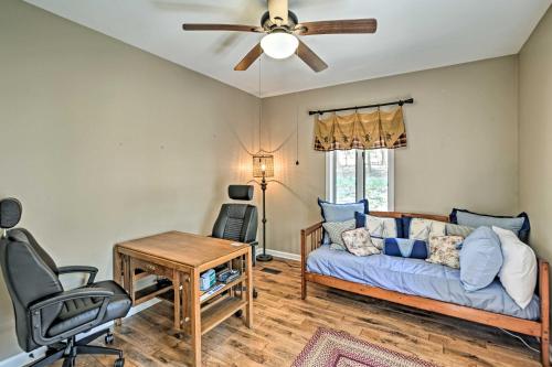 a living room with a couch and a ceiling fan at Family-Friendly Terra Alta Home with Lake View! in Terra Alta