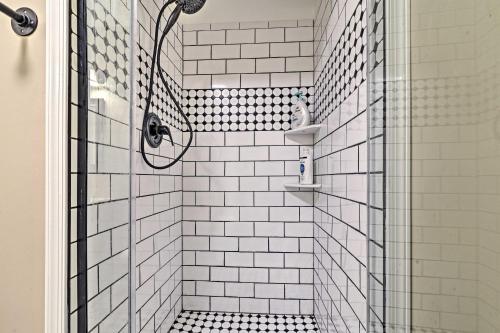 a shower with black and white tiling in a bathroom at Family-Friendly Terra Alta Home with Lake View! in Terra Alta