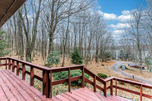 a wooden deck with a view of a forest at Family-Friendly Terra Alta Home with Lake View! in Terra Alta