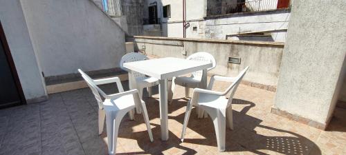 a white table and chairs on a balcony at White House Flats & Studios in Ostuni