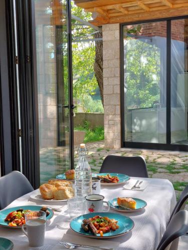 a table with plates of food on top at VILA RIRA - Rrajcë, Shebenik in Përrenjas