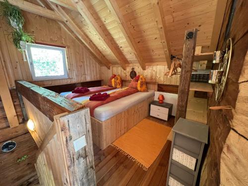 a bedroom of a tiny house with a bed in it at Troadkasten Hollnhof, bezaubernder Panoramablick in Donnersbach