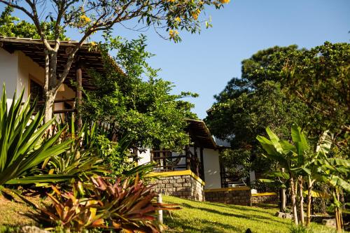 a house with a garden in front of it at Pousada Cabanas da Praia Mole in Florianópolis