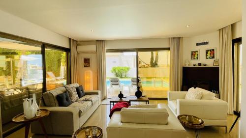 a living room with white furniture and a large window at Praia by Check-in Portugal in Albufeira