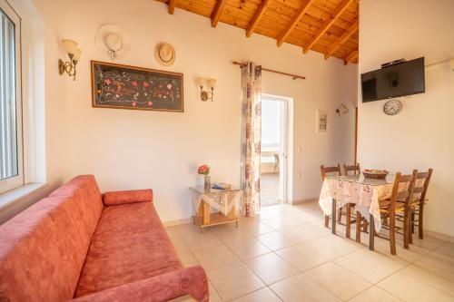 a living room with a couch and a table at Manos Apartments in Almirida