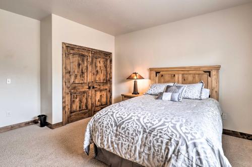a bedroom with a bed and a wooden door at Midway Getaway 17 Miles to Park City Resort! in Midway