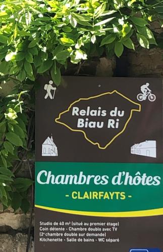 a sign on a wall with a sign for a bike trail at Le Relais du Biau Ri en famille ou entre amis in Clairfayts