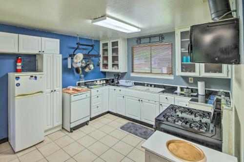 a kitchen with white appliances and blue walls at Gulf Coast Home Less Than 2 Mi to Parks and Museums! in Orange