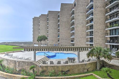 a large building with a swimming pool and a resort at Port Aransas Condo Community Perks, Walk to Beach in Port Aransas