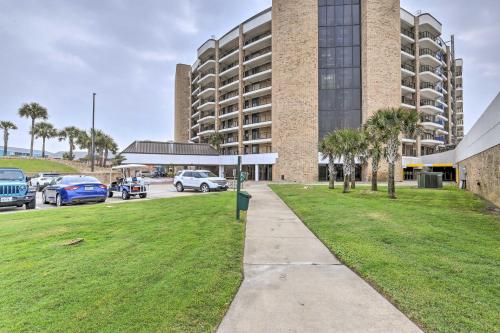 a parking lot in front of a large building at Port Aransas Condo Community Perks, Walk to Beach in Port Aransas