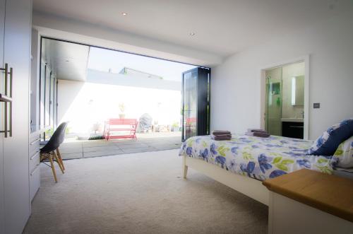 a bedroom with a bed and a sliding glass door at Allen Ridge in Hythe