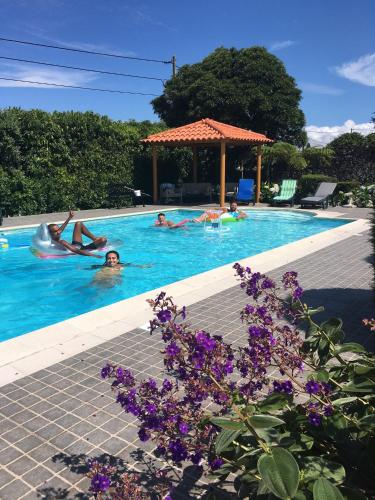 a group of people swimming in a swimming pool at Maria's Haven in Santo António