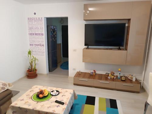 a living room with a television and a coffee table at ally apartament in Constanţa