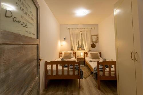 a small room with two beds and a mirror at Apartman Tina in Metković
