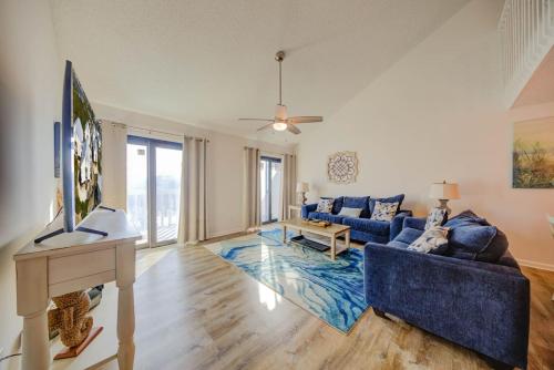 a living room with a blue couch and a table at Cotton Bayou 7H by Vacation Homes Collection in Orange Beach