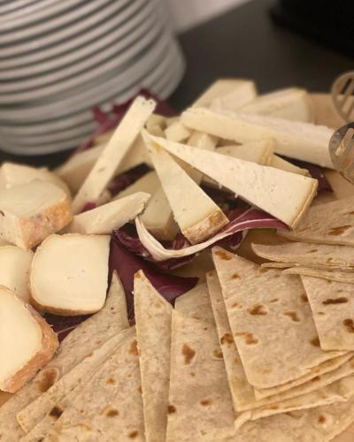 a plate of food with cheese and crackers at Hotel Apogeo - Breakfast Experience in Rimini