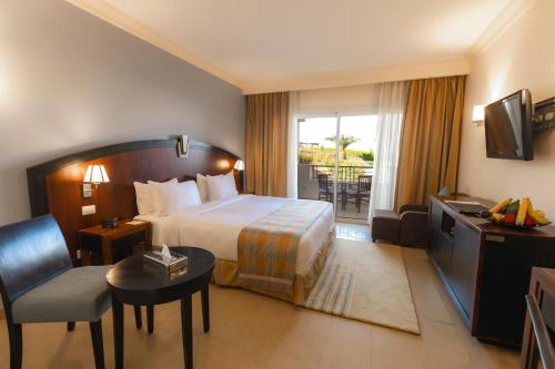 a hotel room with a bed and a balcony at Stella Di Mare Beach Hotel & Spa in Sharm El Sheikh