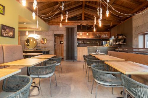 an empty restaurant with wooden tables and chairs at Locanda Milia in Ragalna