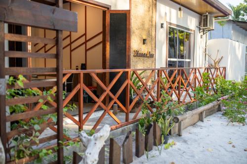 a wooden fence in front of a house at Huvan Inn in Fulidhoo