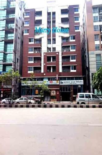 a large building with a sign on the side of it at Marry House in Dhaka