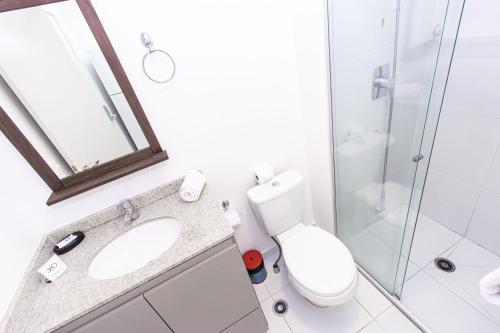 a bathroom with a toilet and a sink and a shower at 360 Suítes Sé in Sao Paulo