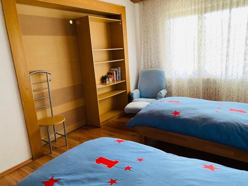 a bedroom with two beds with red stars on them at Enjoy Hiking in Aufseß