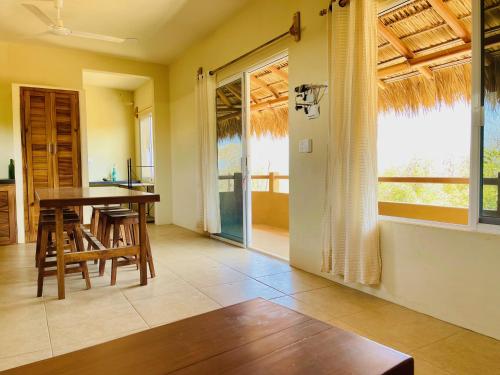 a kitchen and dining room with a table and chairs at Bonobo Living in Puerto Escondido